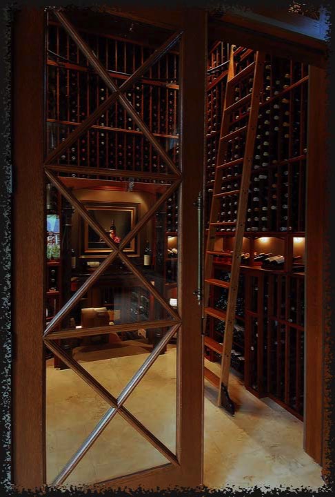 The room's ceiling is roughly twelve feet high.  The upper storage areas are accessed by a rolling library ladder.