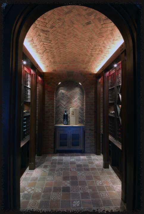 A beautifully prepared room with arched ceiling covered in herringbone brick veneer tiles and a bricked niche centered on the end wall.