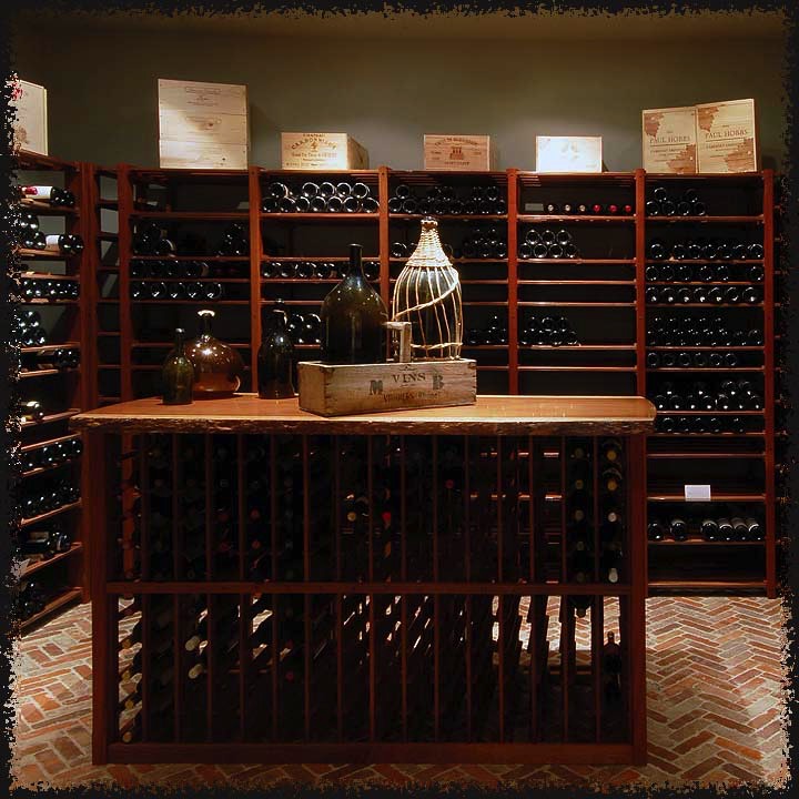 Shelf racks along the walls provide for flexible, high capacity storage while the library racks in the center island are suited to the one or two 'orphans' left from a case.