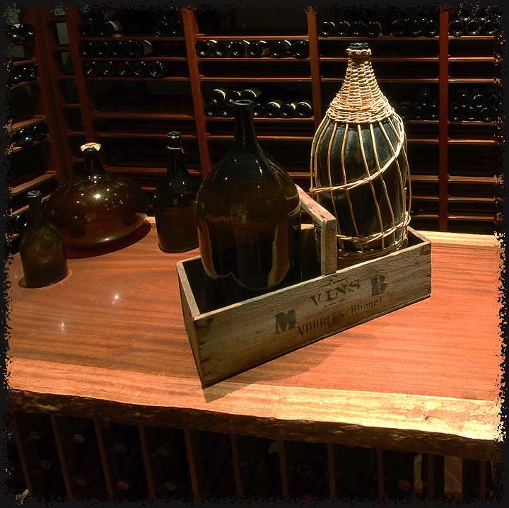 A closer look at the polished Brazilian jatoba top. Several of the collector's antique bottles provide interest.